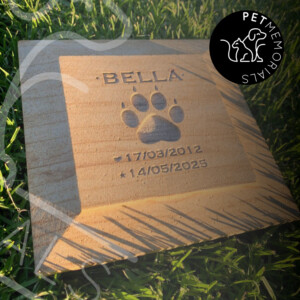 Sandstone pet grave marker engraved with name, paw print and dates