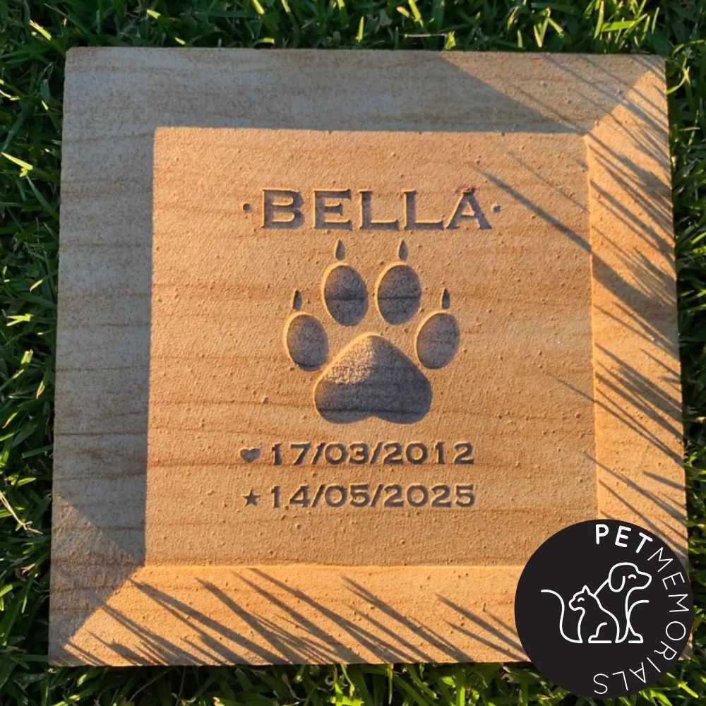Sandstone pet grave marker engraved with name and paw print